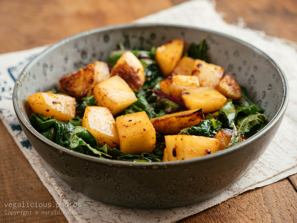 Stock photo of Roasted turnips with sauteed cabbage greens