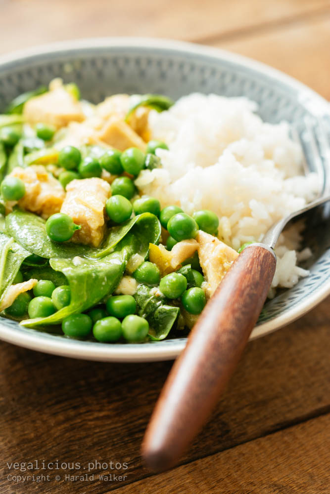 Stock photo of Vegan Thai Green Curry with Chickun, Spinach and Fresh Garden Peas