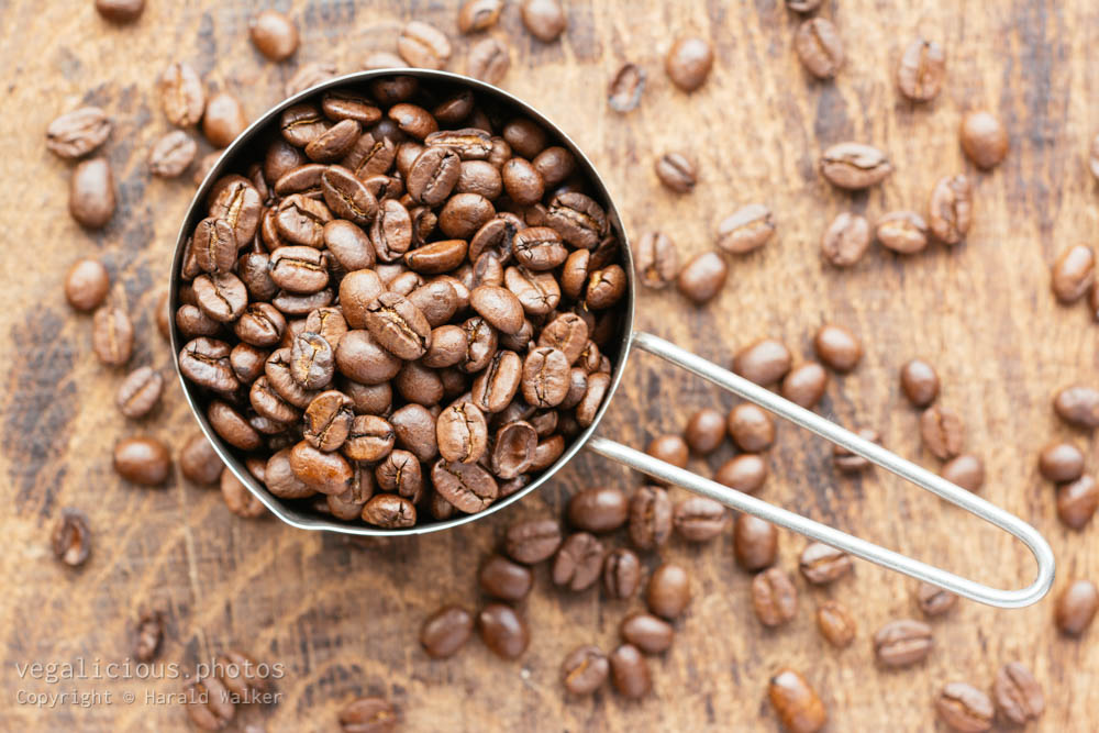 Stock photo of Measuring cup of coffee beans