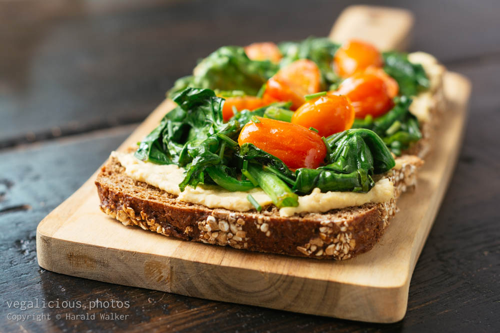 Stock photo of Hummus Toast with Spinach and Cherry Tomatoes