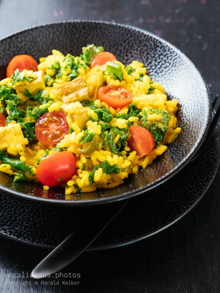 Stock photo of Turmeric Risotto with Kale, Smoked Tofu and Cherry Tomatoes