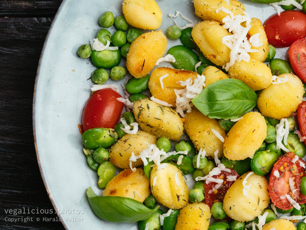 Stock photo of Gnocchi with fava beans, peas and tomatoes
