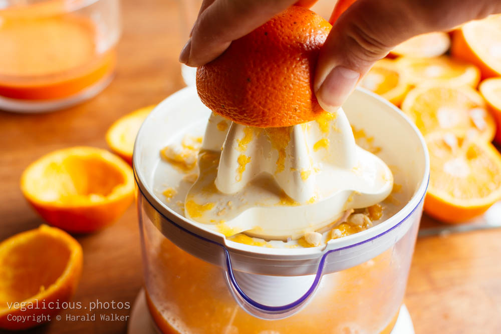 Stock photo of Squeezing an orange on a citrus juicer