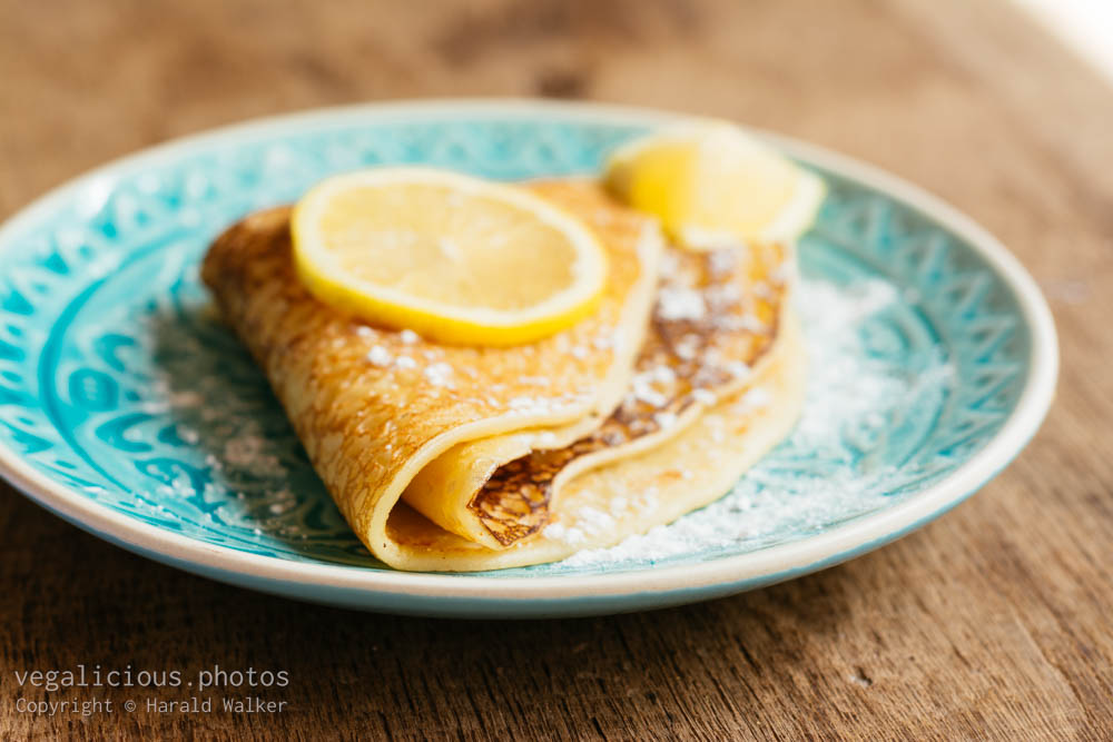Stock photo of Sugar powdered pancakes with lemon.