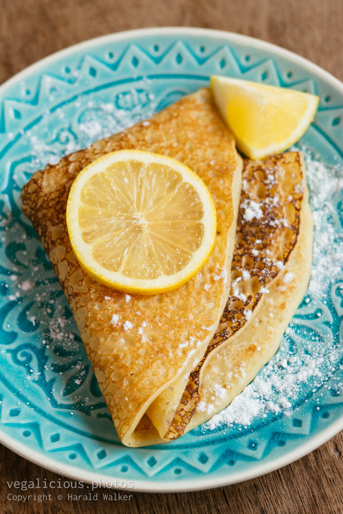 Stock photo of Sugar powdered pancakes with lemon.