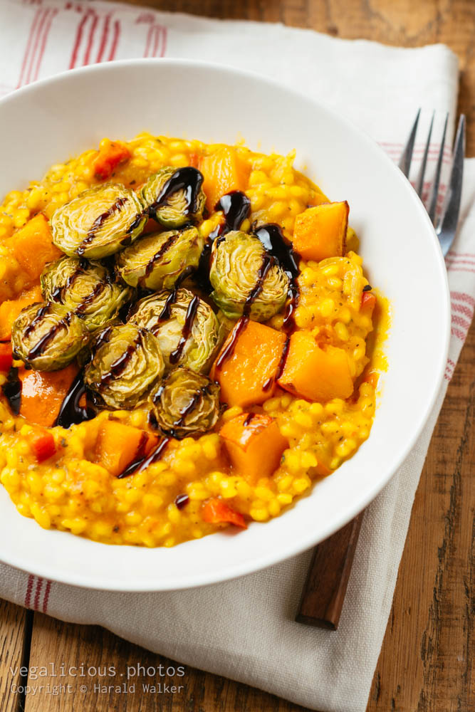 Stock photo of Squash Risotto with Roasted Brussels Sprouts and Balsamic Vinegar Reduction