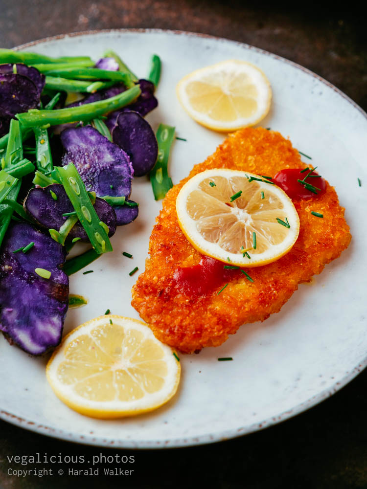 Stock photo of Purple Potatoes with Green Beans and Vegan Schnitzel
