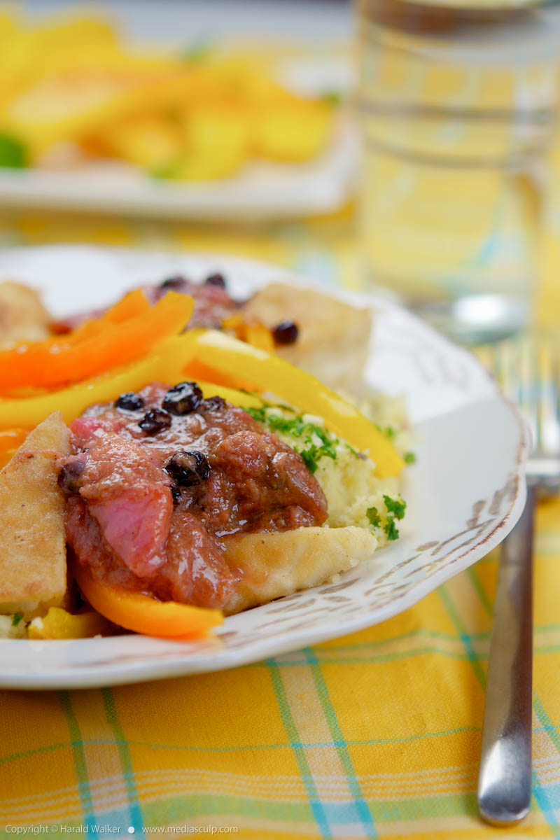 Stock photo of Tofu Cutlets On Couscous with Sweet Peppers and Rhubarb Chutney