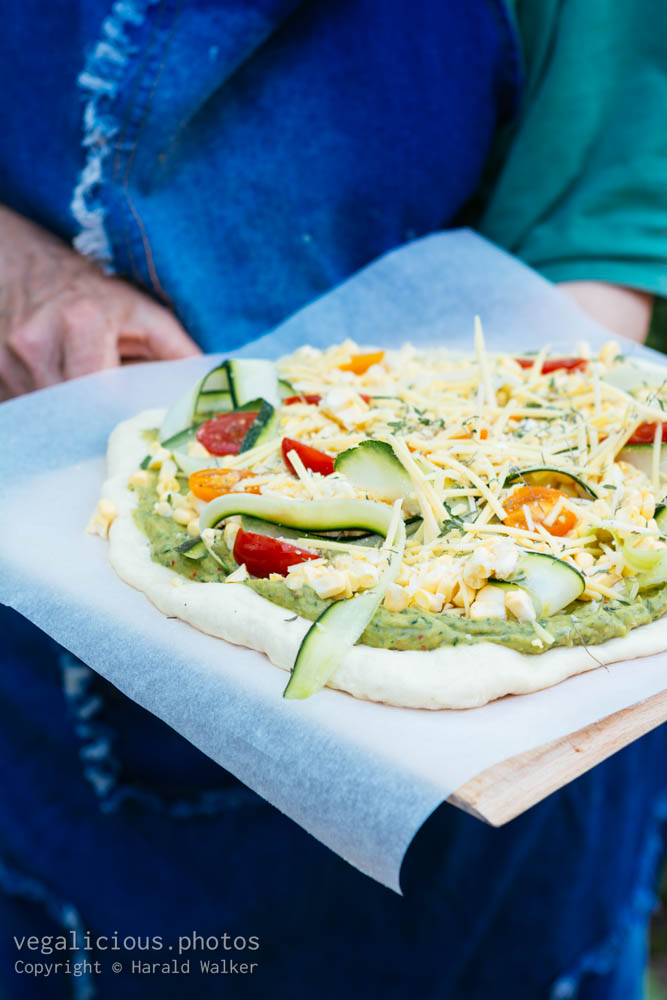 Stock photo of Corn and zucchini guacamole pizza