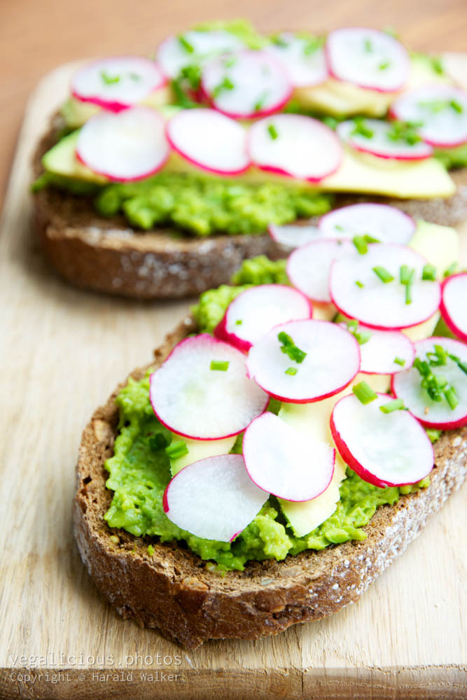 Stock photo of Green Pea Spread Toast with Avocado and Radishes
