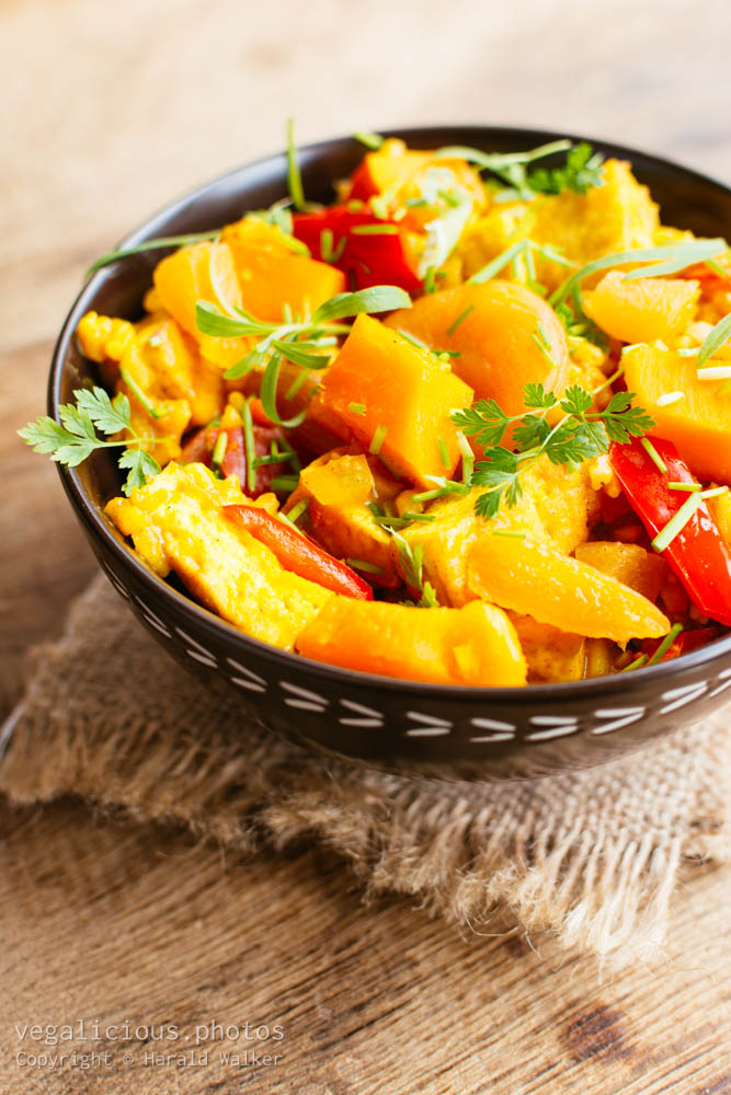 Stock photo of Pumpkin risotto with tofu, apricots, bell pepper and herbs