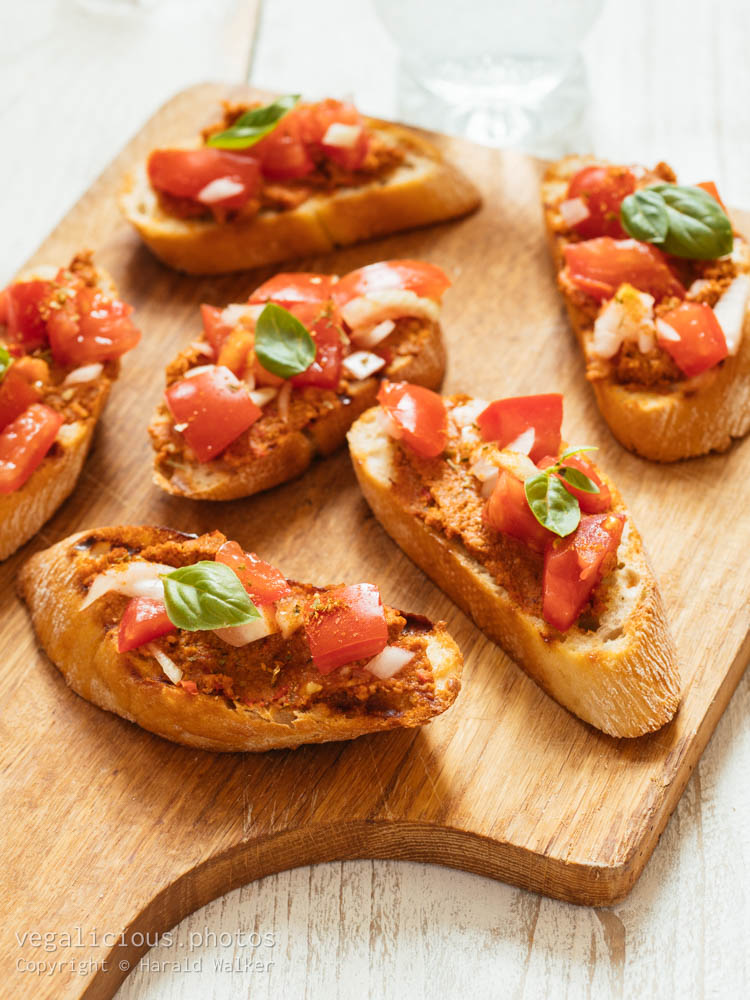 Stock photo of Bruschetta with Muhammara Spread and Chopped Tomatoes